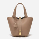 Piana bucket bag in taupe vegan leather with gold lock and pebbled texture