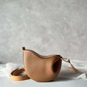 Toscana brown leather cross body bag with curved design and adjustable strap