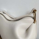 Toscana white leather cross body bag with gold hardware and curved design