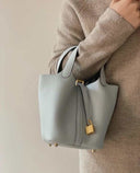 Piana bucket bag in premium vegan leather with golden lock and pebbled texture, compact and stylish handbag